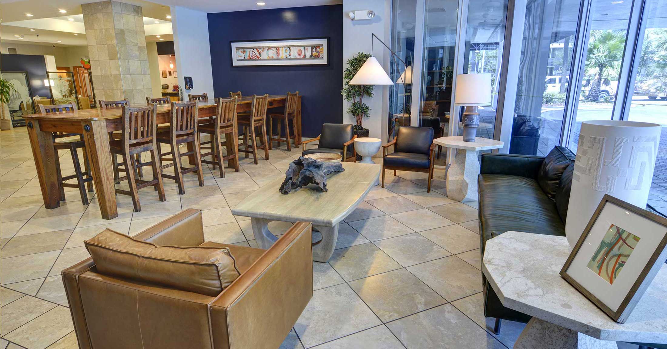 alternate view of lobby seating area and large wooden community table