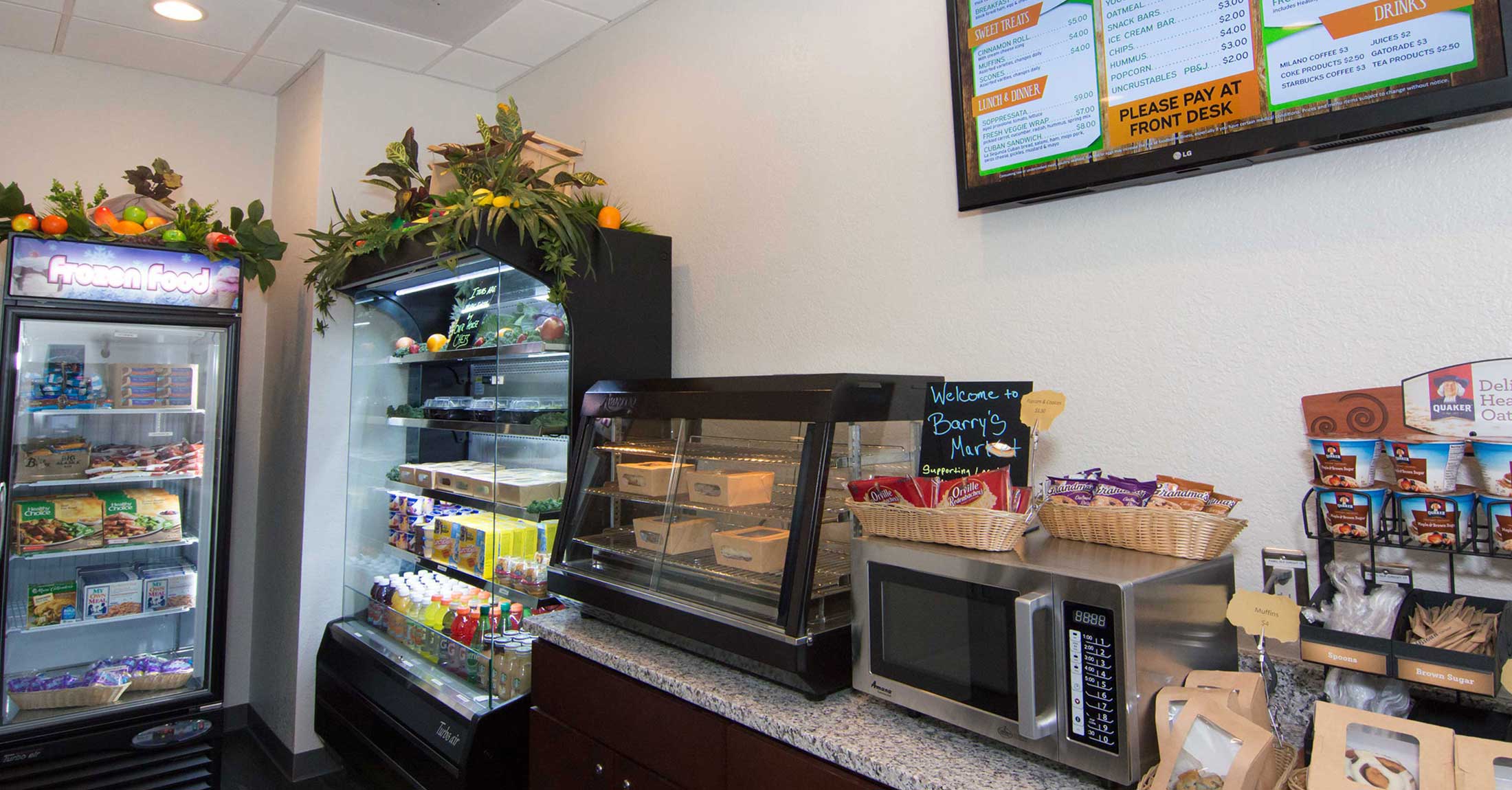 view inside barry's market, cooler and snacks on counter