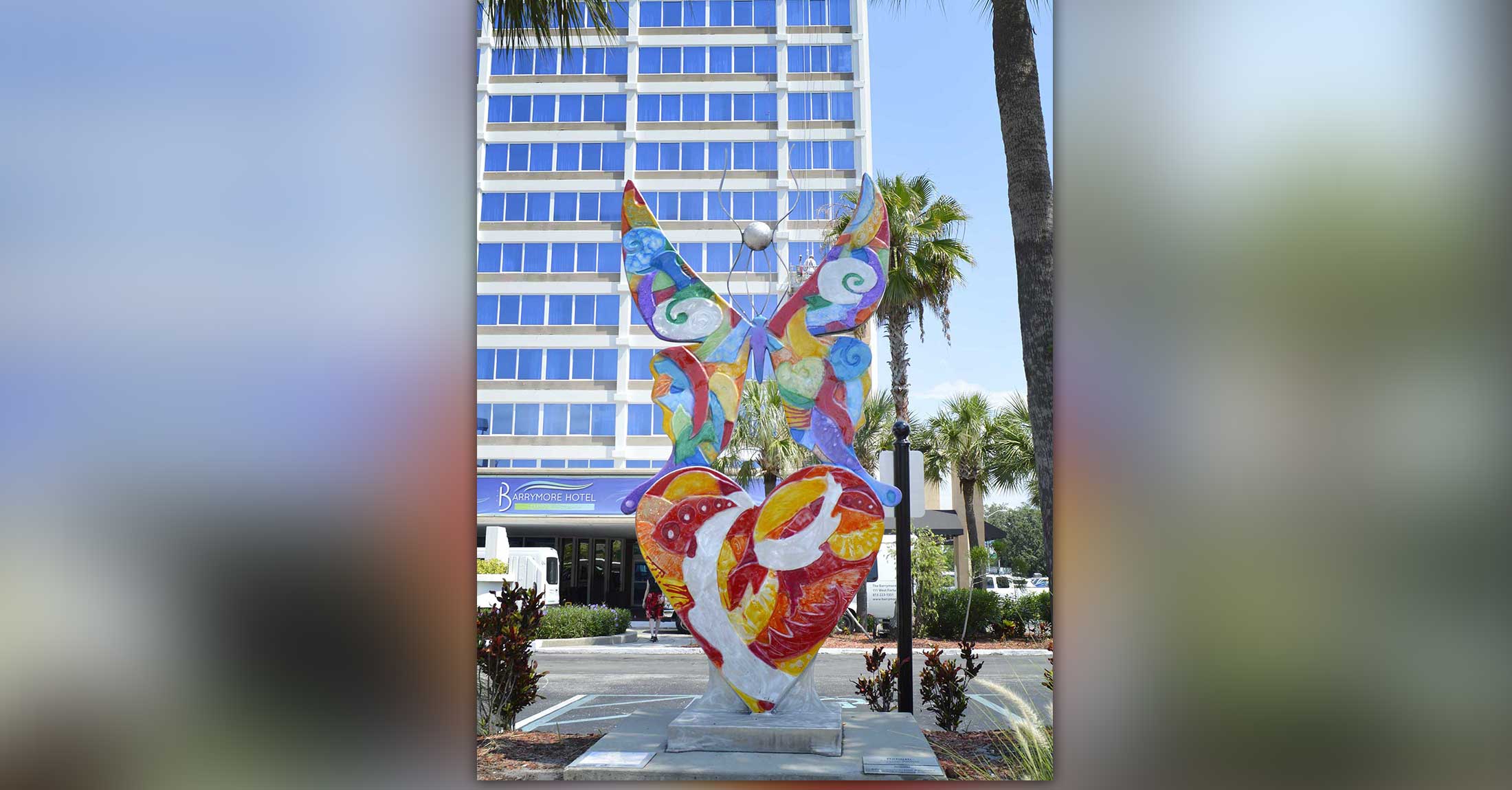 colorful butterfly statue in front of hotel