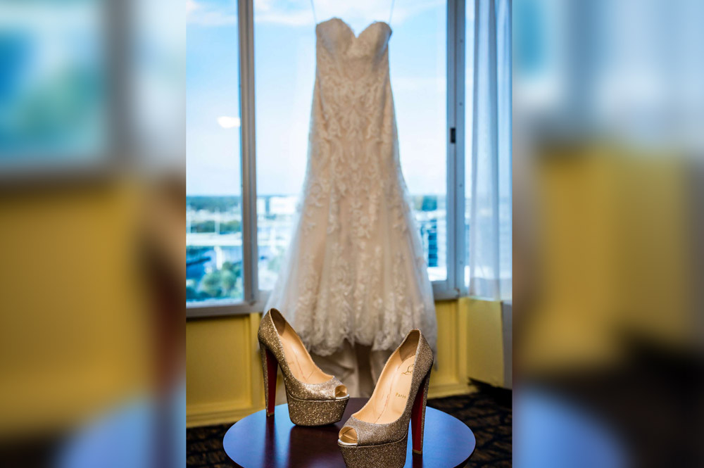 Sparkling gold shoes and wedding dress in window