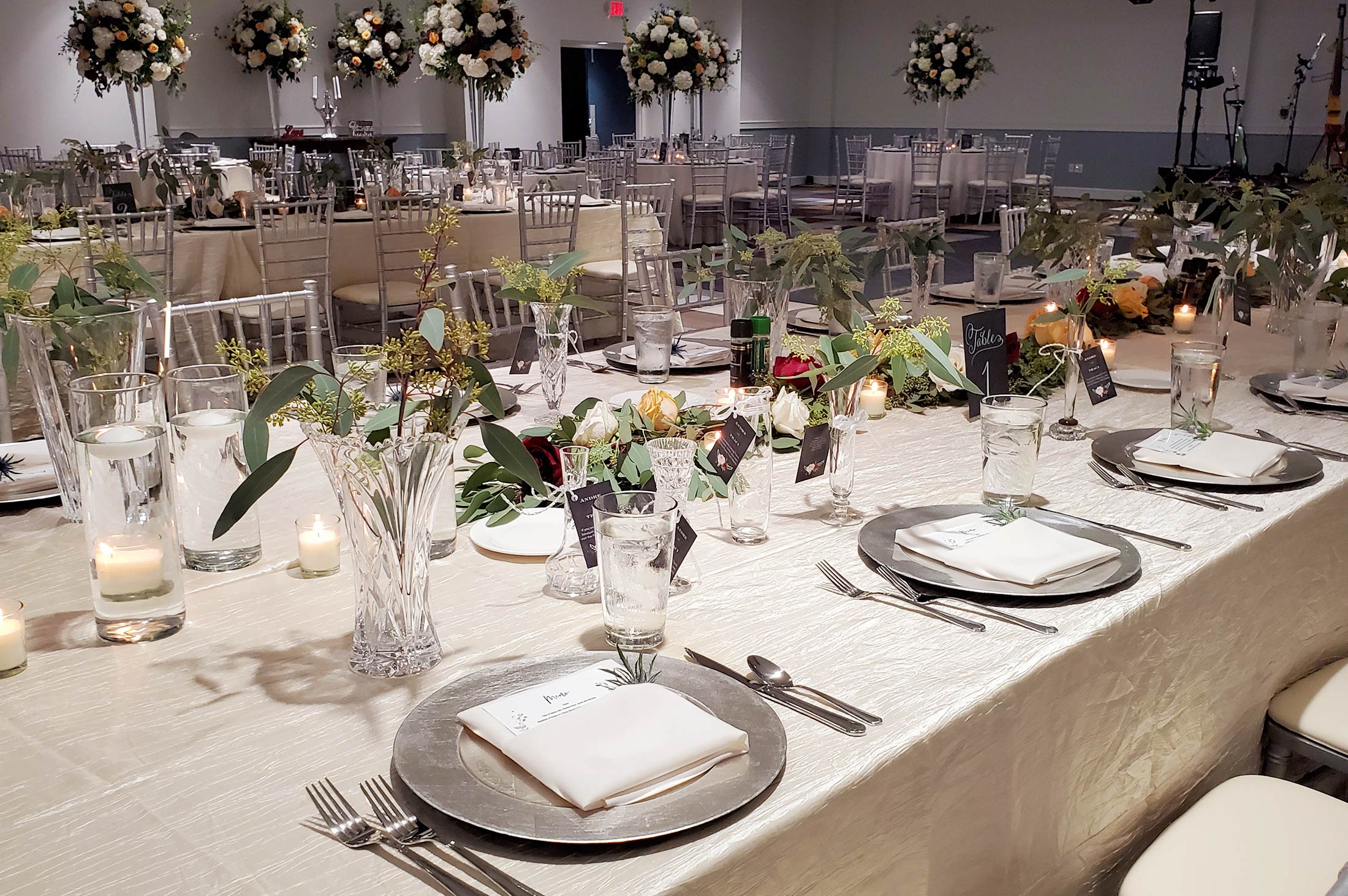 dining in ballroom at reception, plate and table arrangements