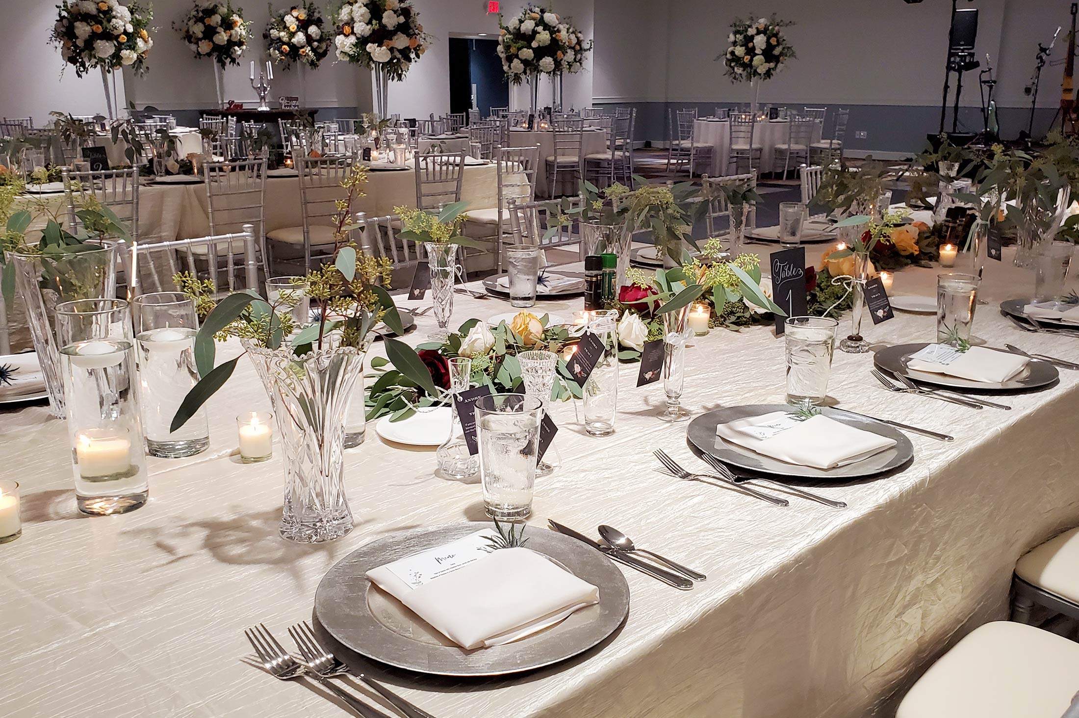 banquet round table with tall large floral arrangement in center